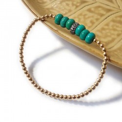 Armband mit runden goldenen und türkisfarbenen Perlen