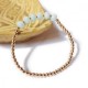 Armband mit goldenen Perlen und facettiertem Aquamarin